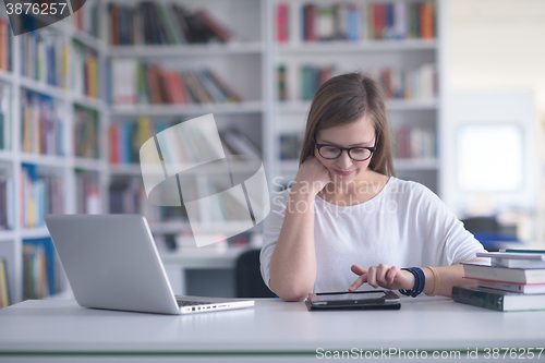 Image of female student study in school library