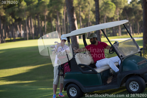 Image of couple in buggy on golf course