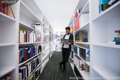 Image of student with tablet in library
