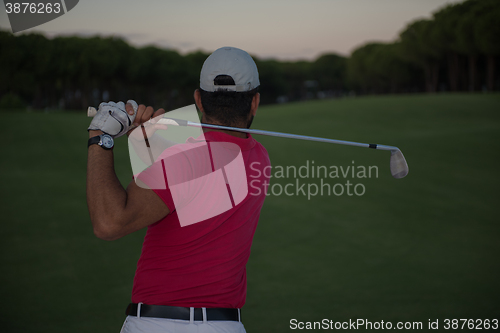 Image of golfer hitting a sand bunker shot on sunset