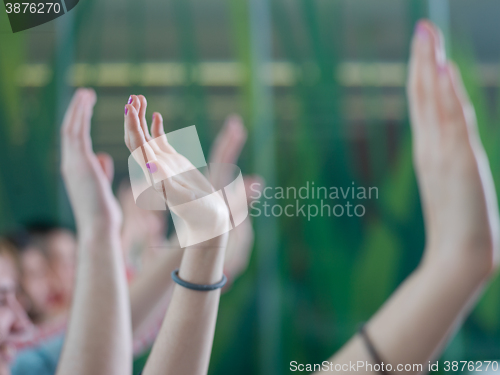 Image of students group raise hands up on class