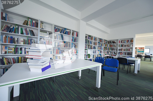 Image of female student study in library, using tablet and searching for 