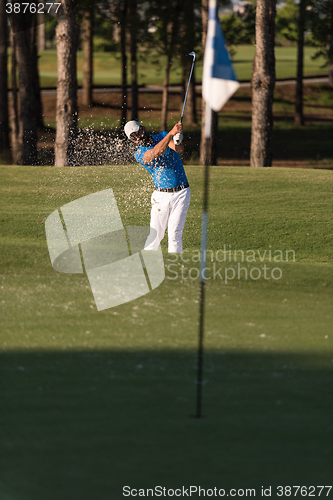 Image of pro golfer hitting a sand bunker shot