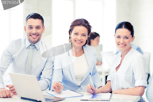 Image of business team discussing something in office