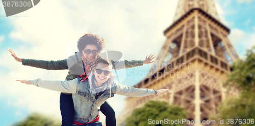 Image of happy teenage couple over paris eiffel tower