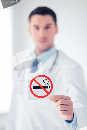 Image of male doctor holding no smoking sign