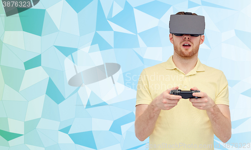 Image of man in virtual reality headset with gamepad