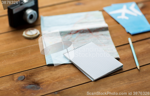 Image of close up of notepad with map and travel tickets