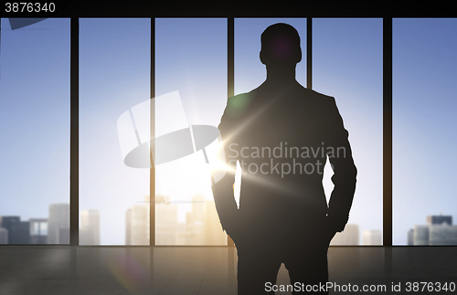 Image of silhouette of business man over office background