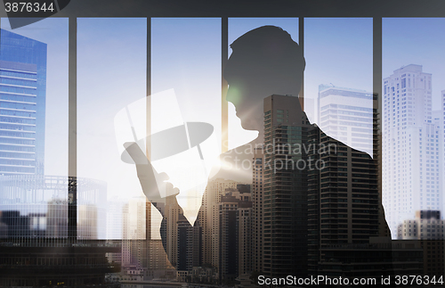 Image of silhouette of businessman with smartphone