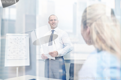 Image of smiling business people meeting in office