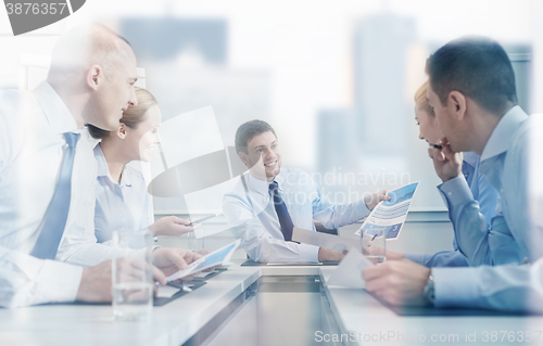 Image of group of smiling businesspeople meeting in office