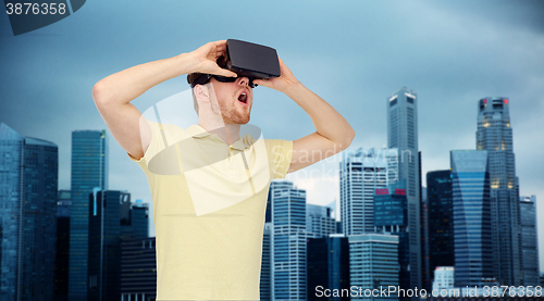 Image of happy man in virtual reality headset or 3d glasses