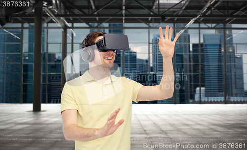 Image of happy man in virtual reality headset or 3d glasses