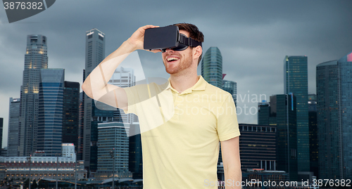 Image of happy man in virtual reality headset or 3d glasses