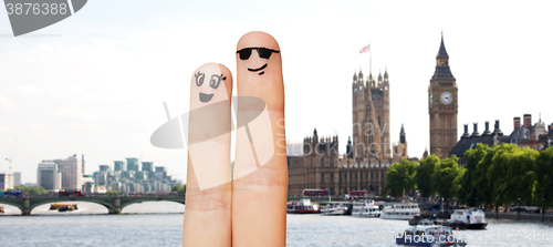 Image of close up of two fingers with smiley faces