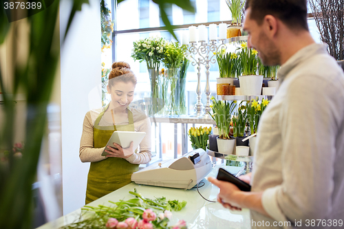 Image of florist woman and man making order at flower shop