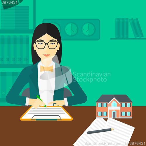 Image of Real estate agent signing contract.