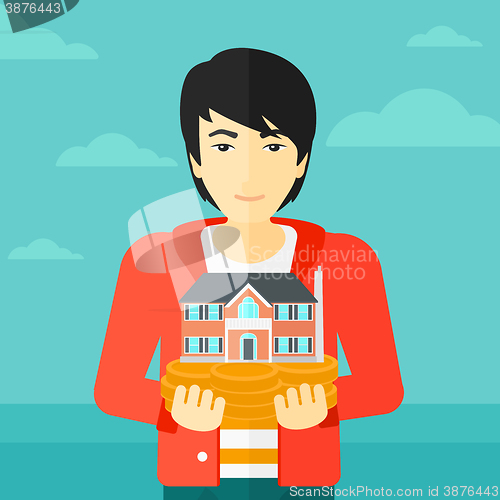 Image of Man holding house model.