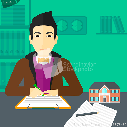 Image of Real estate agent signing contract.