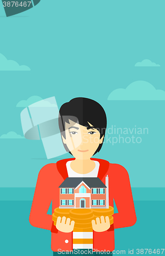 Image of Man holding house model.