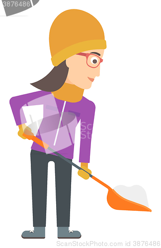 Image of Woman shoveling and removing snow.