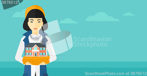 Image of Woman holding house model.