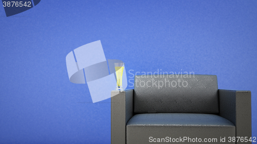 Image of black leather chair and a glass of beer