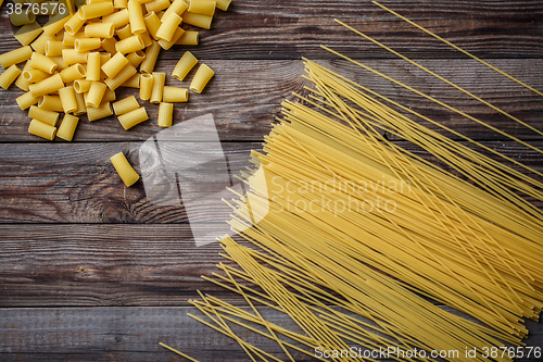 Image of close up portrait of raw homemade italian pasta, macaroni, spaghetti, and fettuccine