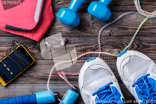 Image of Sport stuff on wooden table, top view