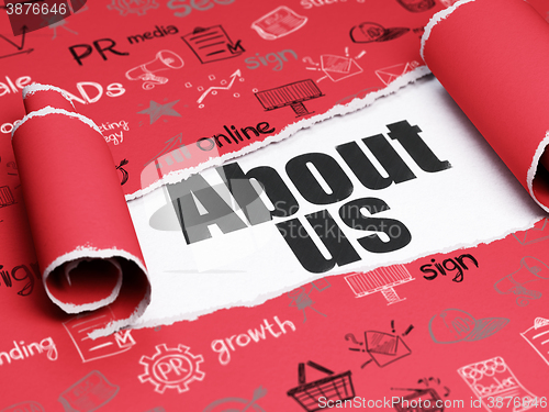 Image of Marketing concept: black text About Us under the piece of  torn paper