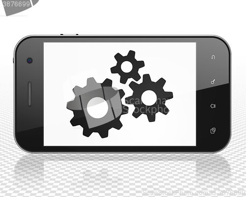 Image of Advertising concept: Smartphone with Gears on display