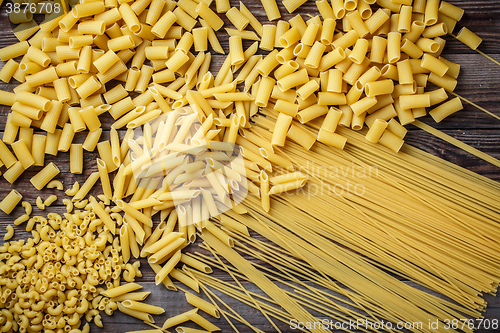 Image of close up portrait of raw homemade italian pasta, macaroni, spaghetti, and fettuccine