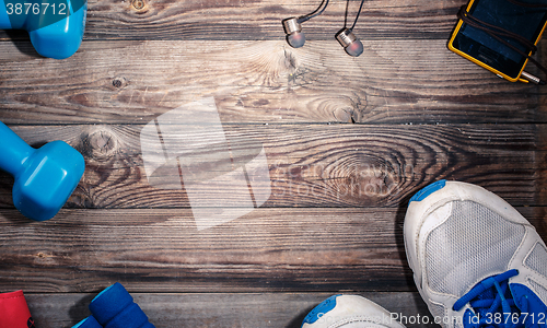 Image of Sport stuff on wooden table, top view