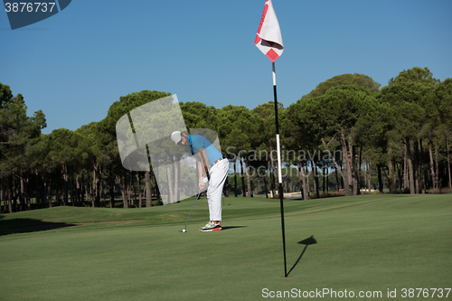 Image of golf player hitting shot at sunny day