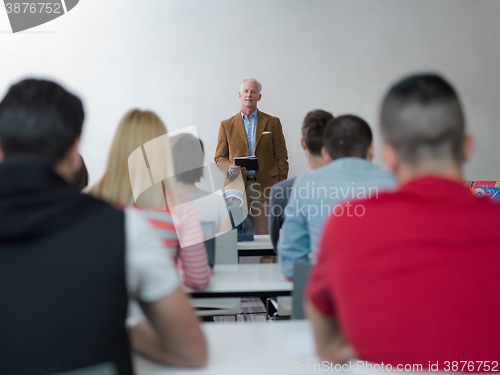 Image of teacher with a group of students in classroom