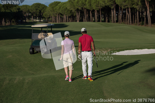 Image of couple walking on golf course