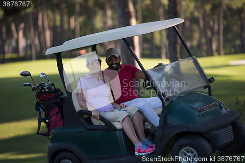 Image of couple in buggy on golf course