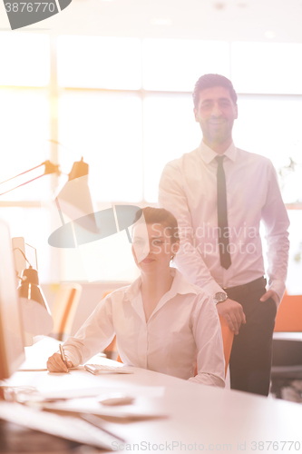 Image of business couple working together on project, sunrise in backgrou