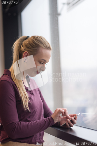 Image of business woman using smart phone at office