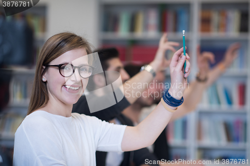 Image of group of students  raise hands up