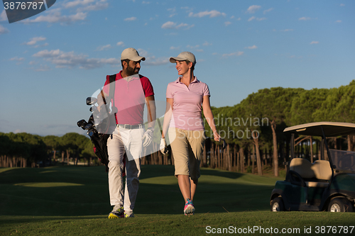 Image of couple walking on golf course