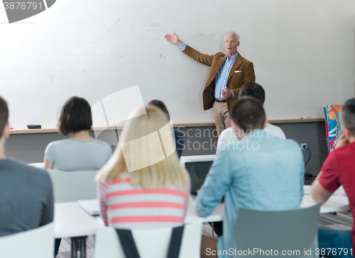 Image of teacher with a group of students in classroom