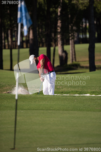 Image of golfer hitting a sand bunker shot