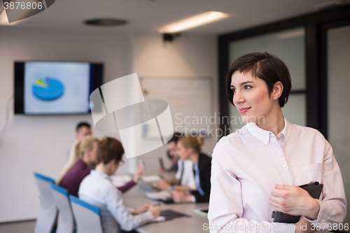 Image of hispanic businesswoman with tablet at meeting room