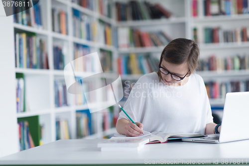 Image of female student study in school library