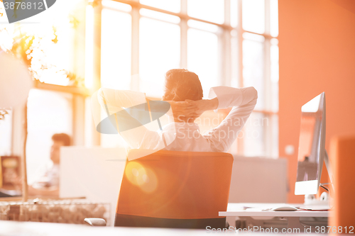 Image of young business woman relaxing at workplace