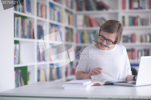 Image of female student study in school library