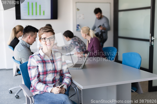 Image of portrait of young business woman at office with team on meeting 