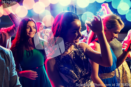 Image of smiling friends dancing in club